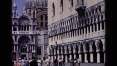 1960: people gathered outside next to a historic old building
