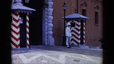 1960: sentry man standing in front of the entrance of a spectacular building