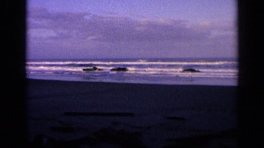 1963: the waves are coming from the ocean at the morning sunrise time.