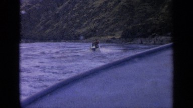 1963: footage of ocean, mountains and a jet ski from a boat. IDAHO