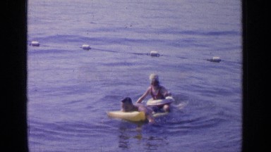 1964: father and daughter play on floatation device GREENWOOD LAKE NEW YORK