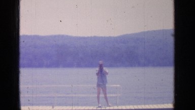 1964: the boy laydown on the board and the girl take it photograph GREENWOOD