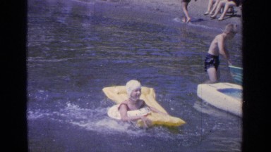 1964: children and parents having fun on a typical holiday at the beach
