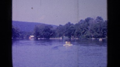 1964: a peaceful nature with river and the people watching it at the morning