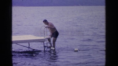 1964: a man getting in and out of water. GREENWOOD LAKE NEW YORK