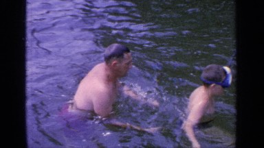 1964: a man playing in the water with a young boy. GREENWOOD LAKE NEW YORK