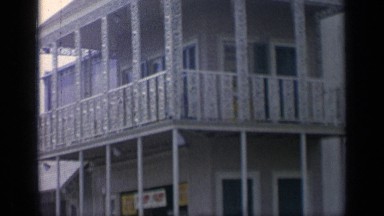 1964: scene of people walking around, shopping, and trading outside in a sunny
