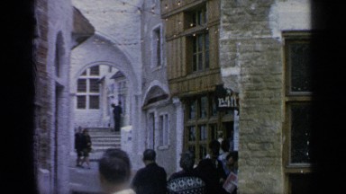 1964: group of tourists walking around and admiring medieval places