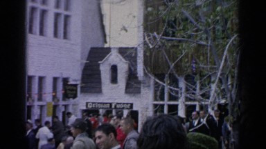 1964: people gather along the quaint streets of a european village.