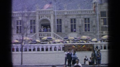 1964: people gathered outside doing many different things. WORLDS FAIR NEW YORK