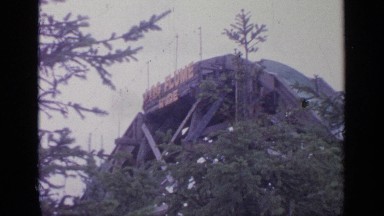 1964: people having fun riding and down a waterslide at an amusement park.