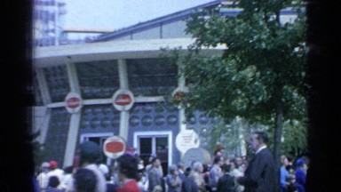 1964: people are located and walking in front of building at the morning time.