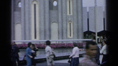 1964: people are standing near the building WORLDS FAIR NEW YORK