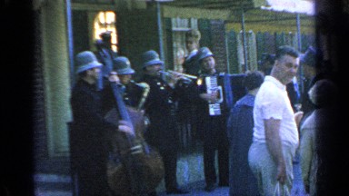 1964: policemen playing violin, saxophone, piano and trumpet at street festival