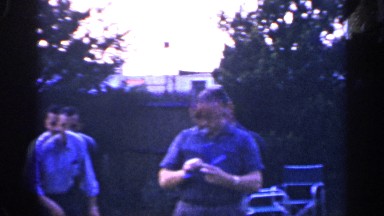 1965: two adult men play a game of ring toss in a back garden. LONG ISLAND