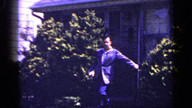 1965: near the houses ,a person standing near the door of house LONG ISLAND