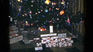 1965: A Christmas Tree with Presents Underneath Sits in a Living Room