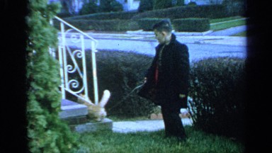 1965: the boy playing with their animal in front of his house LONG ISLAND