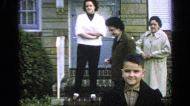 1965: the boy standing in front of the video and his family member behind him