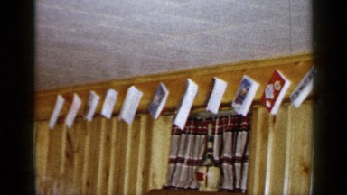 1965: Christmas Cards Hang Evenly Along Wall Trim in Wood-Paneled Room