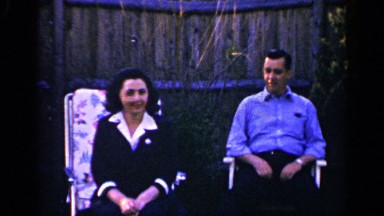 1965: a young couple chatting while sitting in chairs outdoor LONG ISLAND