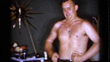 1966: two men are showing their arms and enjoying at their home
