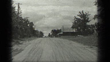 1939: two women walked on road and water source and trees