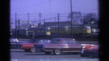 1965: yellow passenger trains ease their way along a city street. OHIO