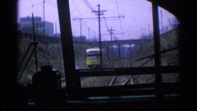 1976: a train going down the railroad tracks, seen from inside the engine's