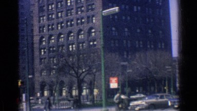 1976: the multiple building are main city and variety of vehicle of main road