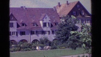 1961: Mother Pulls Child Along Nature Path Near Building in Switzerland