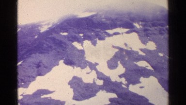 1961: Aerial Vista of a Snow-Covered Mountain Top in Switzerland