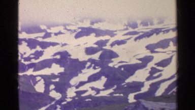 1961: beautiful footage of snow covered mountains taken from above. SWITZERLAND