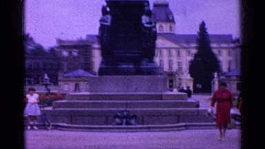 1961: two ladies are walking around the park and a big statue