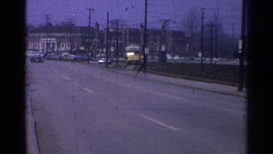 1965: street scene showing small town with yellow electric train. OHIO