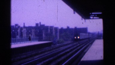 1965: train slowly arriving at the railway station in the twilight OHIO