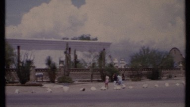 1971: People Standing Outside in Front of a Unique Spanish-Style Building