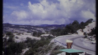 1971: a snow road, a shop, two cars parked in front of shop CALIFORNIA