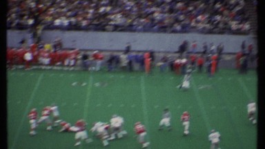 1979: two college teams playing a game in a stadium with lots of people. ITHACA
