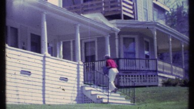 1984: an old lady climbing up the stairs of the building in the landscape