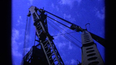 1970: construction site with many pieces of equipment and pieces of brick
