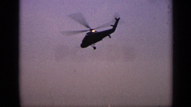 1970: helicopter flies into the sunset on a clear day. UNITED KINGDOM