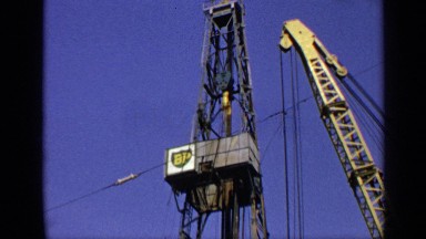 1970: cranes are on both sides of metal tower supporting various platforms