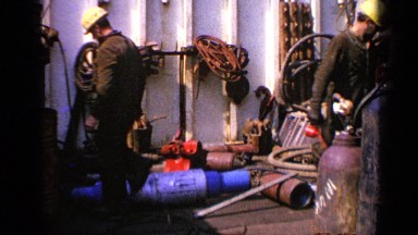 1970: men inspection a factory with their backs turned UNITED KINGDOM