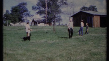 1971: dog is playing with his owner where they are come for vacation CALIFORNIA