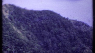 1969: mountain ridge covered in brush with body of water in the background