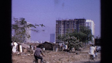 1970: slum area at developed city,planning for building construction,builders