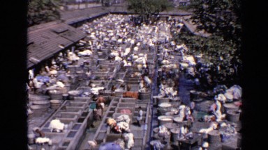 1970: working place consists of many persons doing work as cleaning the cloths