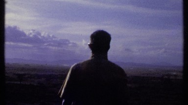 1969: a view of a man standing outside smoking KENYA