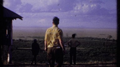 1969: a group of people outside, looking out over an expansive plain KENYA
